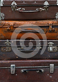 Stack of old vintage travel suitcases close up