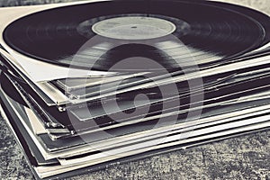 Stack of old vinyl records on the table. Retro style toned image