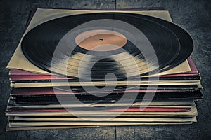 Stack of old vinyl records on the table. Retro style toned image