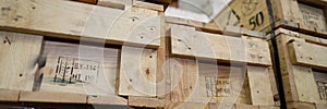 Stack of old wooden packaging boxes standing in column