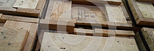 Stack of old wooden packaging boxes standing in column