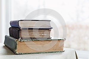 Stack of old worn books on a table