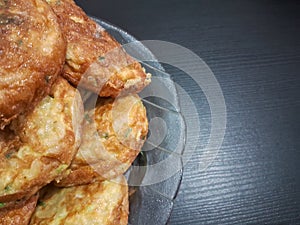 stack of omelettes on a transparent plate on a black background