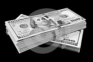 Stack of one hundred dollar bills isolated on black background. Stack of cash money in hundred dollar banknotes. Heap of hundred d