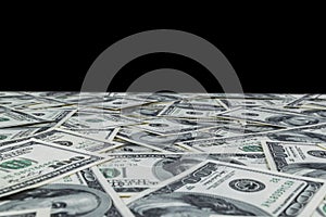 Stack of one hundred dollar bills isolated on black background. Stack of cash money in hundred dollar banknotes. Heap of hundred d