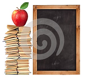 Stack of open books with school blackboard
