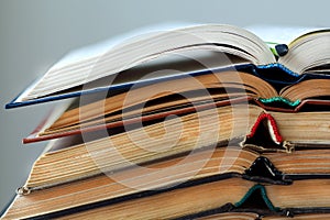 Stack of opened old books, horizontal background