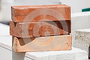 Stack of orange bricks on construction site