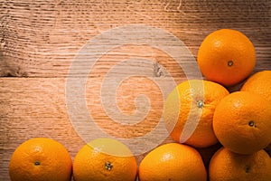 Stack of orange fruits with copyspace on wooden