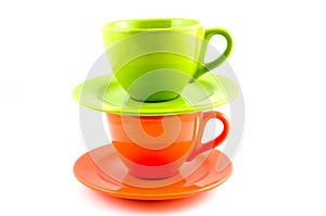 Stack of orange and green coffee cup