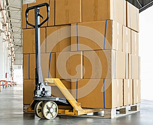 Stack of Package Boxes on Wooden Pallet at Storage Warehouse. Carton Packaging. Cardboard Boxes. Shipment Boxes.