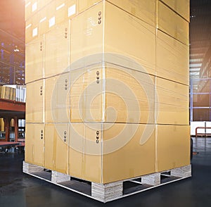 Stack of Package Boxes on Wooden Pallet at Storage Warehouse. Shipment Boxes. Cargo Export- Import.