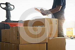 Stack of Package Boxes and Worker is Checking Order Shipment. Delivery Service. Shipment Boxes. Warehouse Inventory Management.