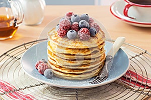 Stack of Pancakes with Berries and Maple Syrup