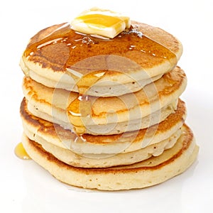 Stack of pancakes with butter isolated on white background