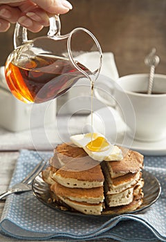 Stack of pancakes with butter and maple syrup