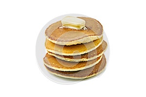 Stack of pancakes with butter piece on white