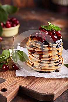 Stack of Pancakes with cherries and chocolate syrup