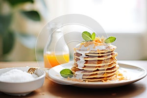 stack of pancakes with coconut milk syrup drizzling on top