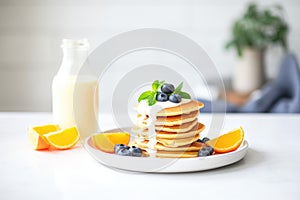 stack of pancakes with coconut milk syrup drizzling on top