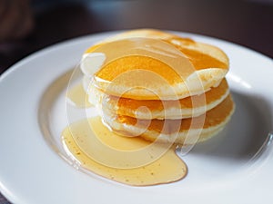 Stack of pancakes dessert with maple syrup