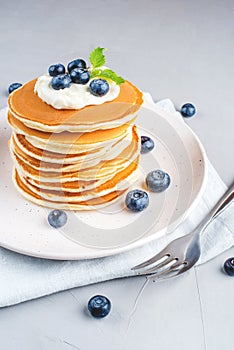 Stack of pancakes with fresh blueberry.