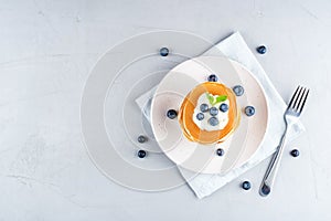 Stack of pancakes with fresh blueberry.