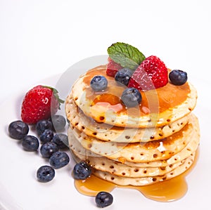 Stack of pancakes with fruits photo