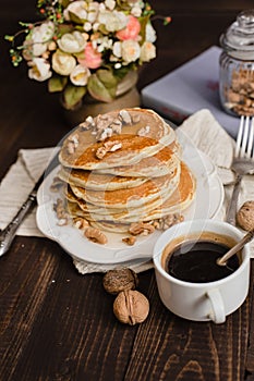 Stack of pancakes with honey,banana and walnuts