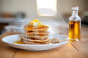 stack of pancakes with maple syrup and butter