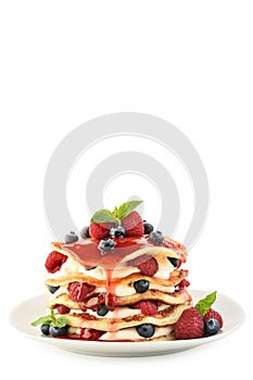 The stack of pancakes on plate with fresh berries