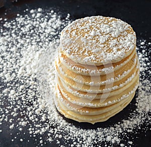 Stack of pancakes with powdered sugar