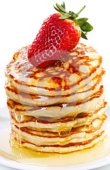 Stack of pancakes with syrup and strawberry