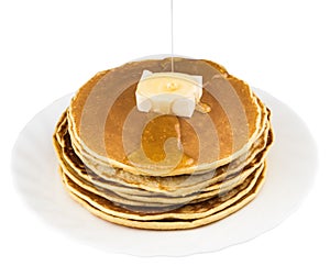 Stack of pancakes in syrup on white background