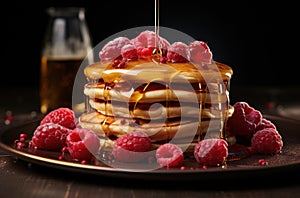 a stack of pancakes on a table with raspberries and maple syrup