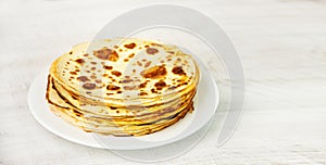 A stack of pancakes on a wooden table