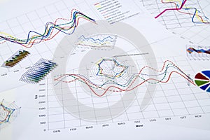 Stack of paper documents with financial reports and statistic in