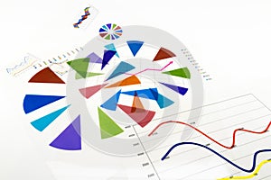 Stack of paper documents with financial reports and statistic in