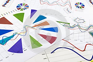 Stack of paper documents with financial reports and statistic in