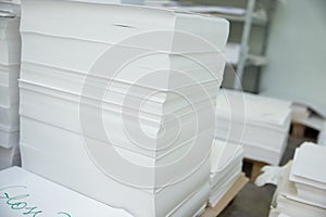 Stack of paper in a printing press.