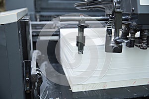 Stack of paper in a printing press.