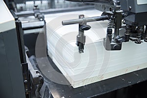 Stack of paper in a printing press.