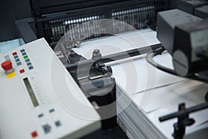 Stack of paper in a printing press.