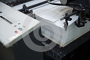 Stack of paper in a printing press.