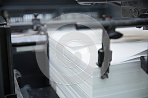 Stack of paper in a printing press.