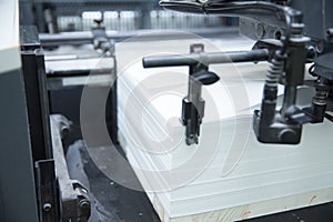 Stack of paper in a printing press.