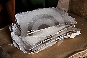Stack of paper sheets in an ancient paper mill. Old traditional
