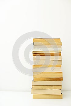 Stack of paperback books against white background with only the pages showing