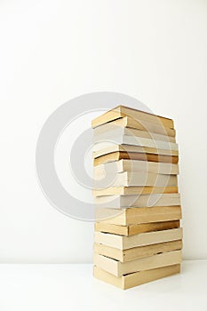 Stack of paperback books against white background with only the pages showing