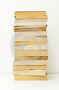 Stack of paperback books against white background with only the pages showing